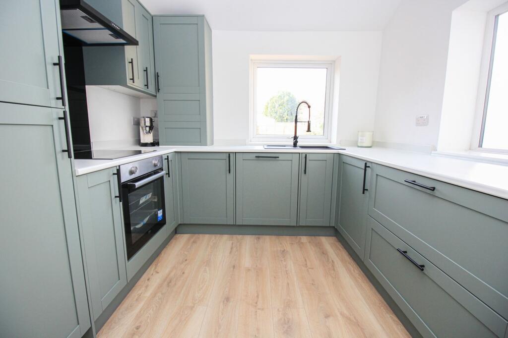 Image of a green shaker style kitchen